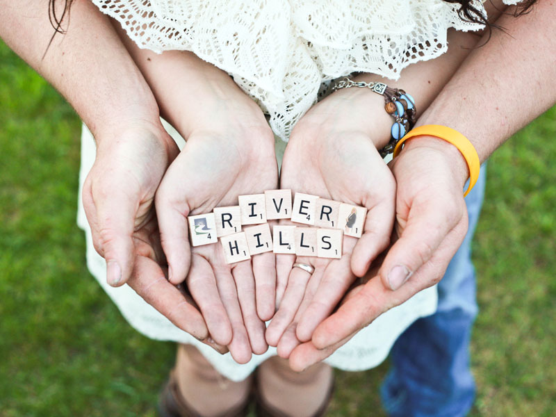 hands holding letters that spell River Hills